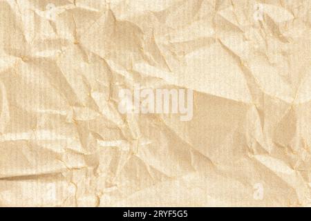 Crumpled Kraft paper texture background. Light golden brown color Stock Photo