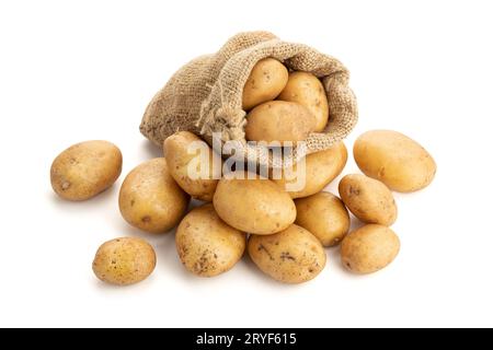 New potatoes in burlap sack isolated on white background. Raw potato Stock Photo