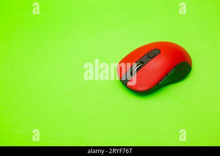 Red wireless computer mouse on Green background with clipping path Stock Photo