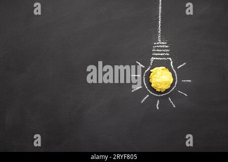 Hand Drawn Light Bulb On blackboard with Copy space. Bright Idea or Creative process concept Stock Photo