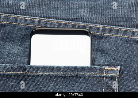 Close up of a smartphone in jeans pocket with white blank screen. Template mock up Stock Photo