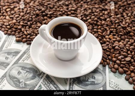 Cup of coffee on Coffee beans and dollar banknotes background Stock Photo