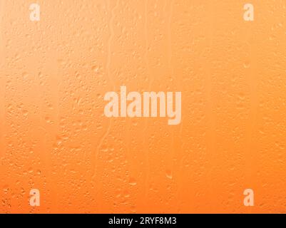 Raindrops on glass window over sunset sky Stock Photo
