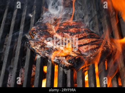 Searing and smoking ribeye steaks on grill Stock Photo