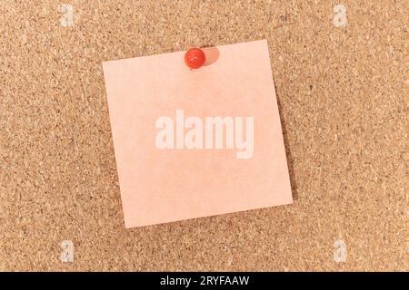 Blank note and push pin on cork board. Template to ad text or drawings Stock Photo