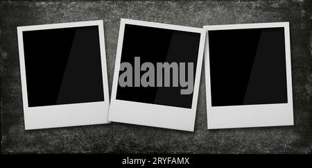 Three empty instant photo frames on wooden table Stock Photo