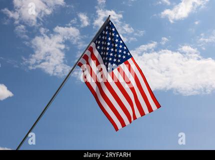 US American flag hanging on flagstaff Stock Photo