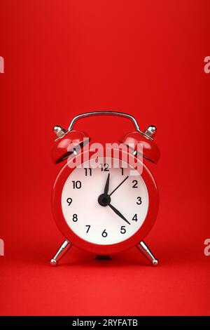 Close up one red alarm clock over red background Stock Photo