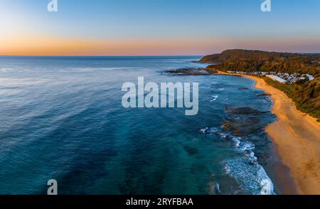 Sunrise seascape with clear skies at Shelly Beach on the Central Coast, NSW, Australia. Stock Photo