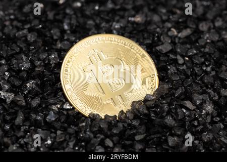 Bitcoin coin on black gravel background. Cryptocurrency blockchain money Stock Photo