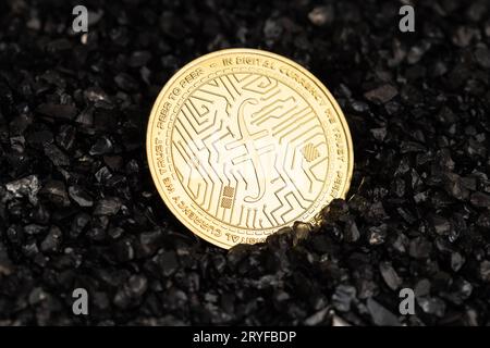 Filecoin coin on black gravel background. Cryptocurrency blockchain money Stock Photo