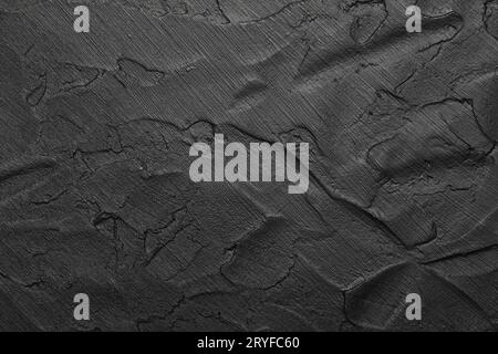 Black uneven grunge surface abstract background Stock Photo