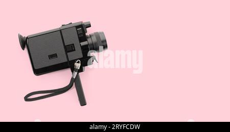Super 8 film camera isolated on pink background. Copy space Stock Photo