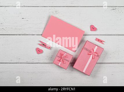 Pink gift boxes and paper note on white table Stock Photo