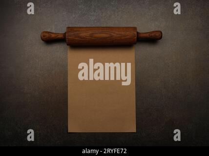 Vintage wooden rolling pin and brown paper Stock Photo