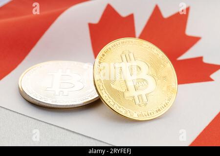 Bitcoin cryptocurrency coins on national flag of Canada. Crypto law regulation concept Stock Photo