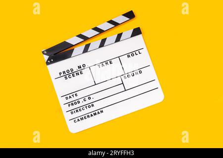 White Movie clapper board isolated on yellow background. Top view Stock Photo