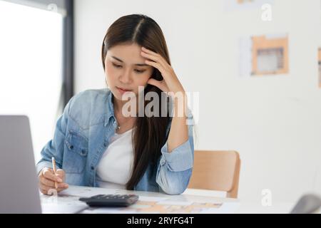 Construction business plan concept, Female architect feeling stressed while sketching house plan. Stock Photo