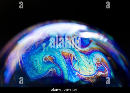 Abstract multicolored pattern, chaotic texture inside of the soap bubble, closeup Stock Photo