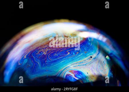 Abstract multicolored pattern, chaotic texture inside of the soap bubble, closeup Stock Photo