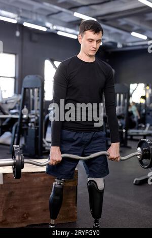 love of life. serious man is concentrated on lifting barbell. side view shot.muscle growth and strength development.gaining muscle mass Stock Photo