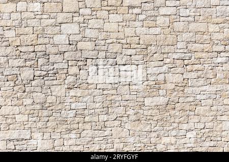 Granite Stone wall background texture. Dry masonry wall Stock Photo