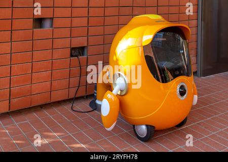 Dubai, UAE - November 28, 2021: Cute robot Opti, the guardian of the Opportunity Pavilion on charge at Expo 2020 in Dubai Stock Photo