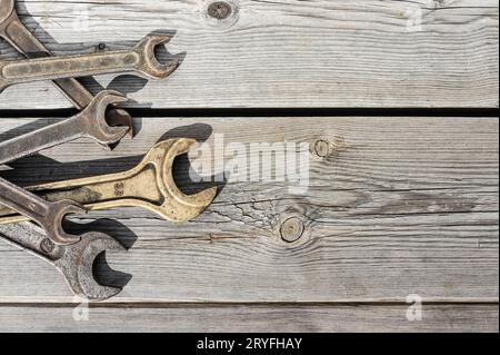 Old rusty wrenches on a wooden table Stock Photo