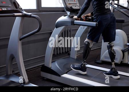love of life. ambitious man without legs running at gym, the impossible is possible , cropped side view shot Stock Photo