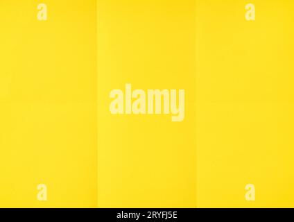 Yellow crumpled unfolded paper sheet texture background. Paper folded in six. Full frame Stock Photo