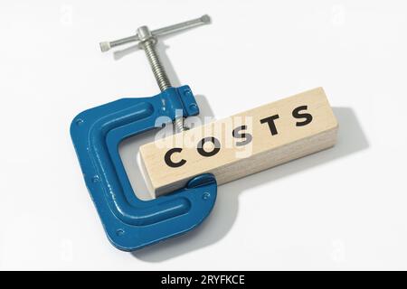 Costs squeeze concept. Clamp clamping down of a wooden block with text on white background Stock Photo