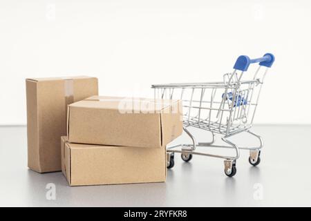 Sale, discount, shopping and delivery concept. Pile of blank Cardboard boxes and shopping cart on white background. Template Moc Stock Photo