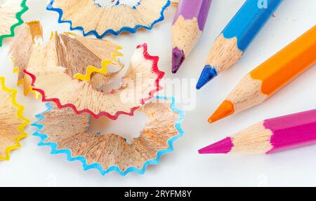 Sharpened colorful pencils and wood shavings, closeup macro Stock Photo