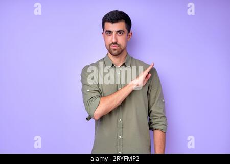 Young bearded deaf mute man saying that he is healthy using sign language on blue background Stock Photo