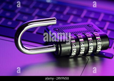 Computer Security Vulnerability concept. Open padlock on laptop with colorful lights Stock Photo