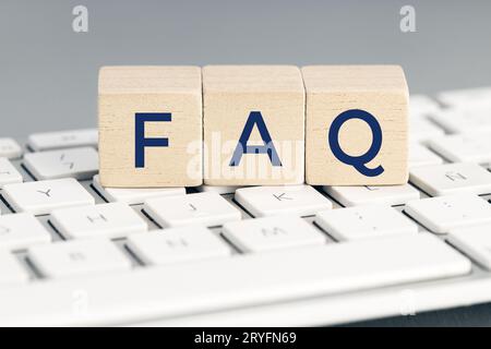 FAQ word on wooden block on computer keyboard. Frequently asked question concept Stock Photo