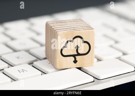 Cloud computing icon on wooden block on computer keyboard Stock Photo