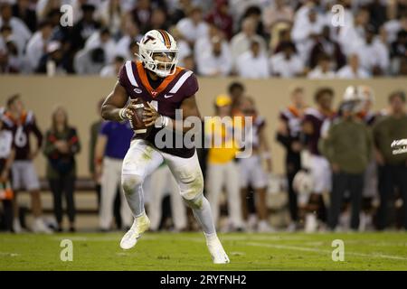 Virginia Tech quarterback Kyron Drones (1) rolls out to throw while ...