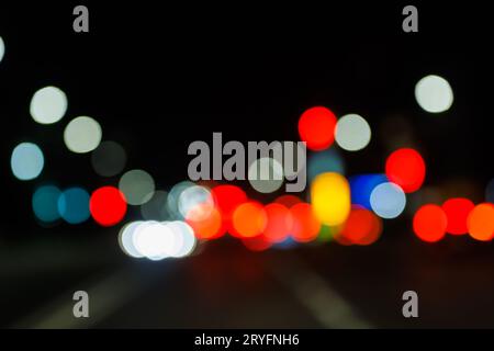 Defocused night street view from drivers perspective Stock Photo