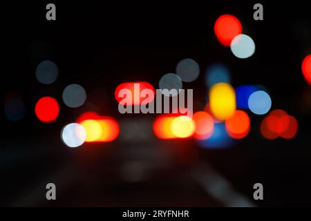 Defocused night street view from drivers perspective Stock Photo