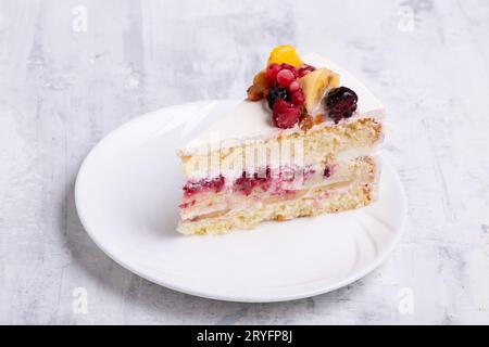 Top view shot of sliced white fruit cake on a white plate Stock Photo