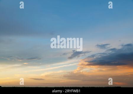 Evening sky, partially covered with differently lighted clouds Stock Photo