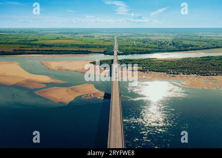 Aerial car bridge over river with sandy dunes coast Stock Photo