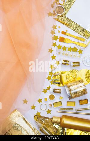 Golden  party decoration. Warm holiday golden and silver glow background. Decor means and tools of gold color. Stock Photo