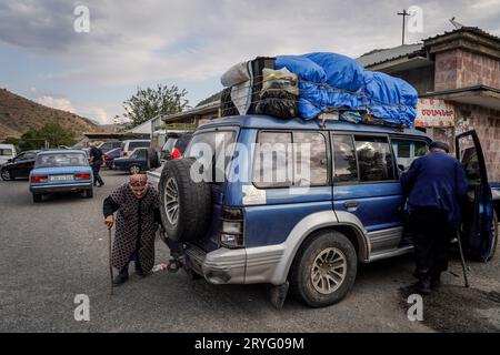 A refugee from Karabakh is seen approaching her vehicles packed with her families' belongings in Vayk, Armenia. Ethnic Armenians from Nagorno-Karabakh have registered in different cities of Armenia, including Vayk and Goris, one of the largest refugees hubs after they were forcefully displaced from their homes. They are provided with food, shelter and basic necessities. As Azerbaijan took control of the southern mountainous region in a military offensive more than a week, tens of thousands of Armenians have left. Armenia's leader says Azerbaijan committing 'act of ethnic cleansing”. According Stock Photo
