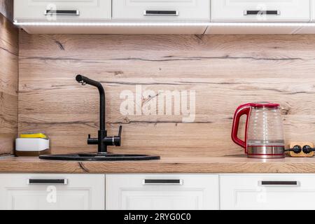 White kitchen set with kitchen utensils on the countertop. Stock Photo