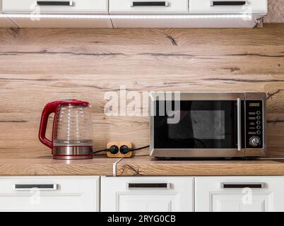 White kitchen set with kitchen utensils on the countertop. Stock Photo