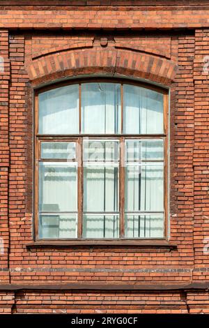 The window of an old house built of red brick Stock Photo