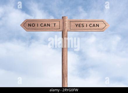 Yes I can concept or No I can not. Signpost with two messages on opposite way and sky background Stock Photo