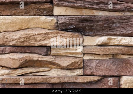 Fake stone wall, plastic panel imitating natural slab wall brickwork Stock Photo